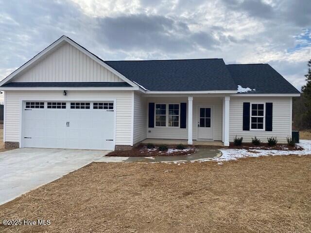 view of front of property with a porch and a garage