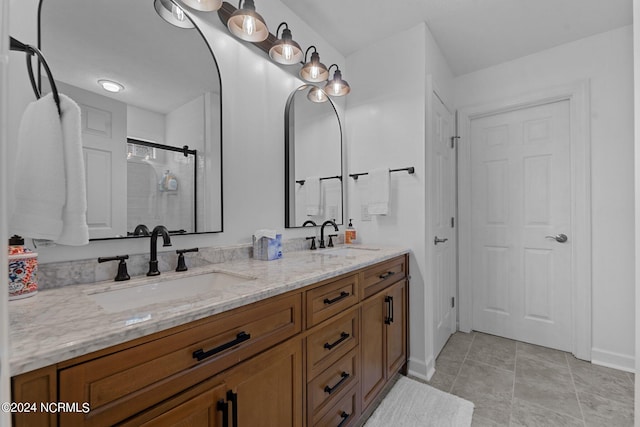 bathroom with vanity, a shower with shower door, and tile patterned floors