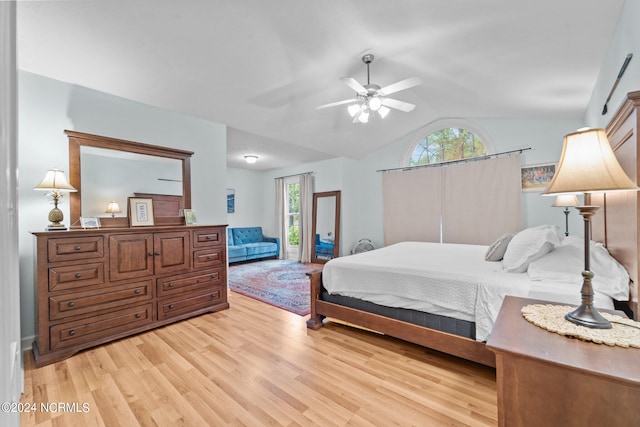 bedroom featuring light hardwood / wood-style flooring, ceiling fan, vaulted ceiling, and multiple windows