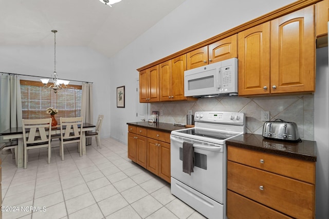 kitchen with white appliances, tasteful backsplash, hanging light fixtures, vaulted ceiling, and a chandelier