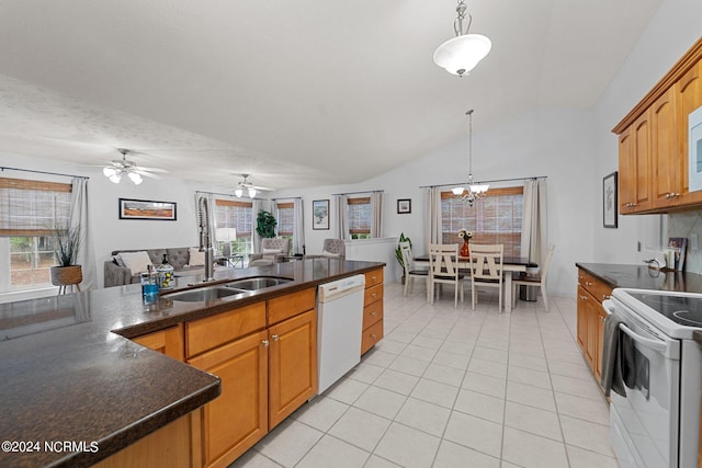 kitchen with white appliances, plenty of natural light, and hanging light fixtures