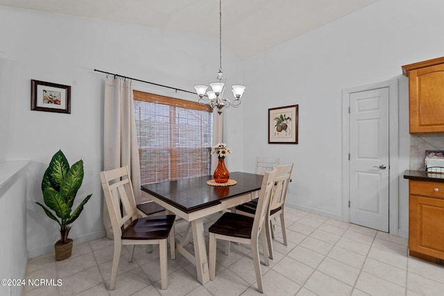 tiled dining room with vaulted ceiling and an inviting chandelier