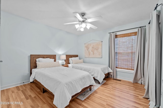 bedroom featuring light hardwood / wood-style floors and ceiling fan