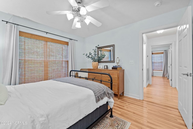 bedroom with light hardwood / wood-style floors and ceiling fan