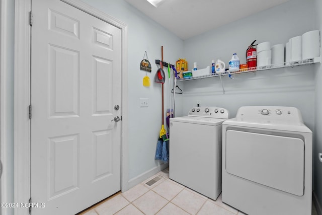 laundry room featuring independent washer and dryer and light tile patterned floors