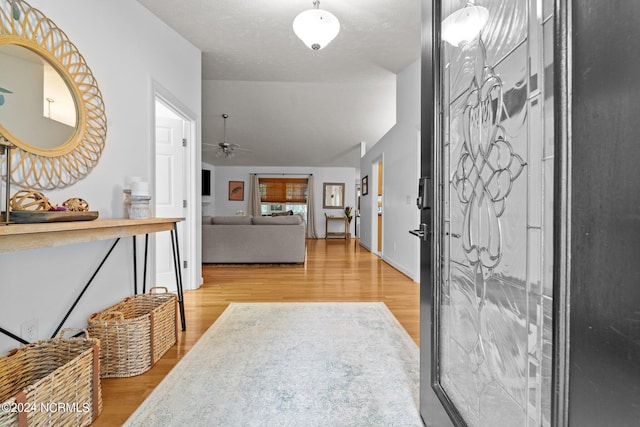 foyer featuring a textured ceiling, hardwood / wood-style flooring, and ceiling fan