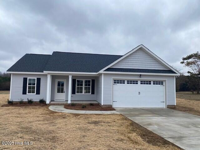 view of front of property featuring a garage and a front yard