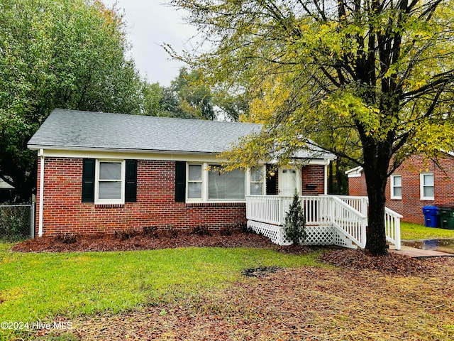 view of front of house featuring a front yard and a deck