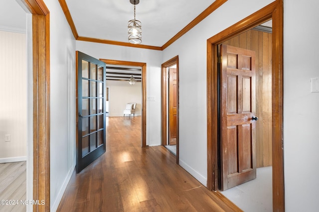 hall featuring light hardwood / wood-style floors and crown molding