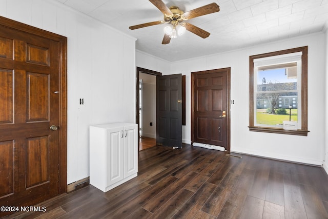 foyer entrance with ceiling fan, dark hardwood / wood-style flooring, and crown molding