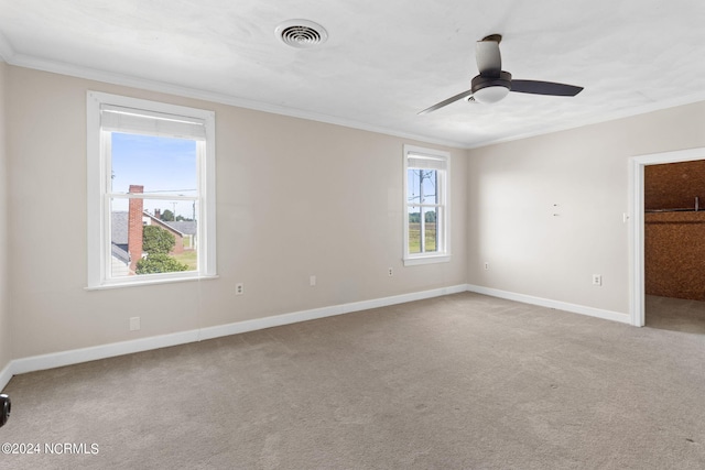 interior space with light carpet, ceiling fan, and ornamental molding