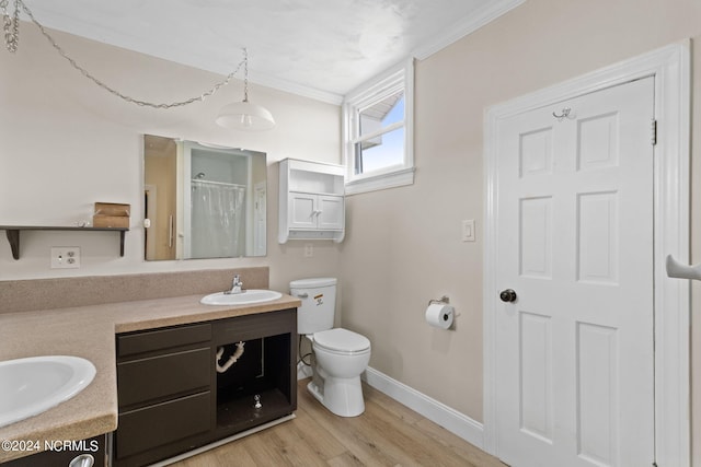 bathroom featuring vanity, hardwood / wood-style flooring, toilet, ornamental molding, and curtained shower