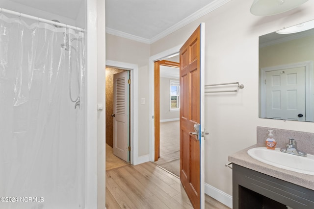 bathroom with vanity, curtained shower, wood-type flooring, and crown molding