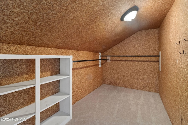 spacious closet with carpet and vaulted ceiling