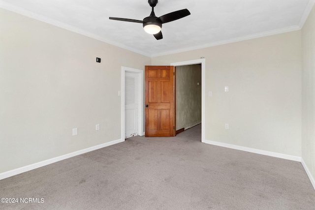 unfurnished room with light colored carpet, ceiling fan, and crown molding