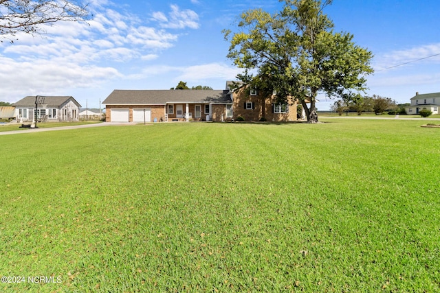 view of front facade featuring a front yard and a garage