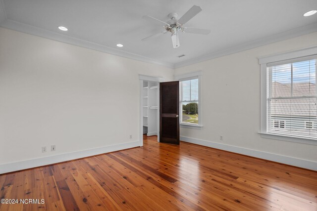 unfurnished room with ornamental molding, hardwood / wood-style floors, and ceiling fan