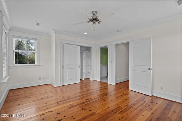 unfurnished bedroom featuring ceiling fan, ornamental molding, a closet, and light hardwood / wood-style floors