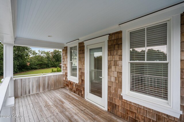 wooden terrace with a porch