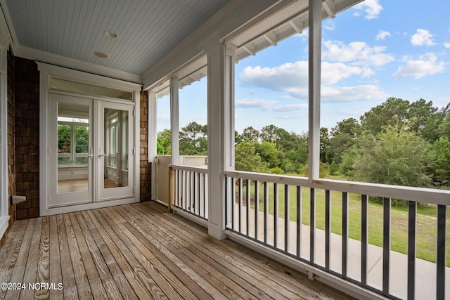 wooden terrace featuring a yard