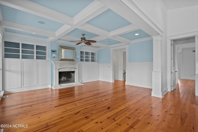 unfurnished living room with crown molding, ceiling fan, a high end fireplace, and light wood-type flooring