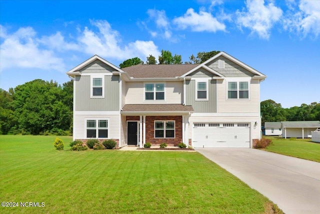 craftsman house featuring a garage and a front lawn