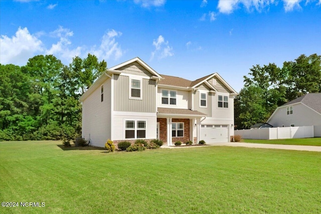 view of front of home with a garage and a front lawn