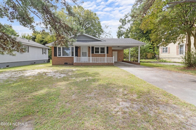 view of front of house featuring a front yard, a carport, and a porch