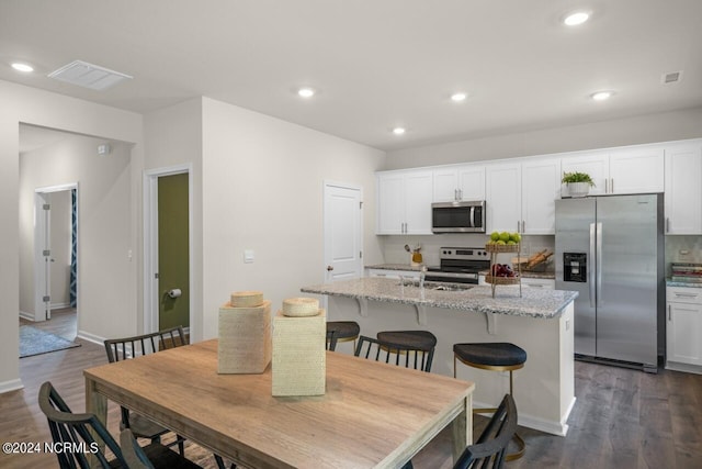 dining area with dark hardwood / wood-style floors