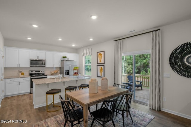 dining space with dark wood-type flooring and sink