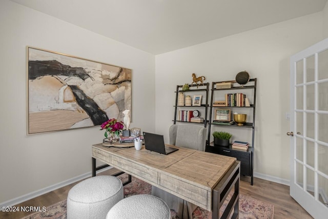 home office with hardwood / wood-style floors