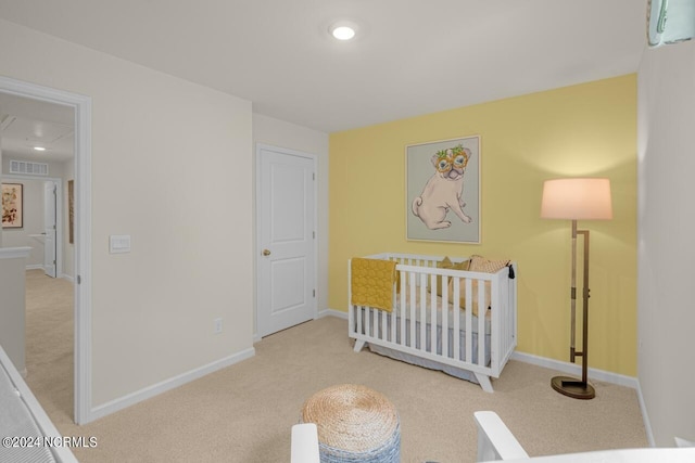 carpeted bedroom with a nursery area