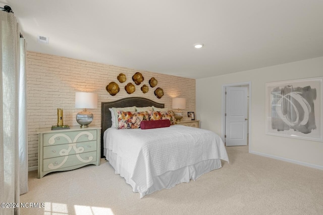 carpeted bedroom featuring brick wall