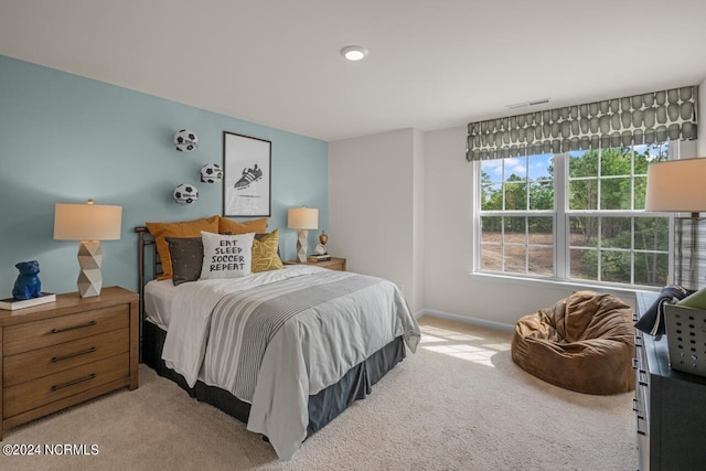 bedroom featuring light colored carpet