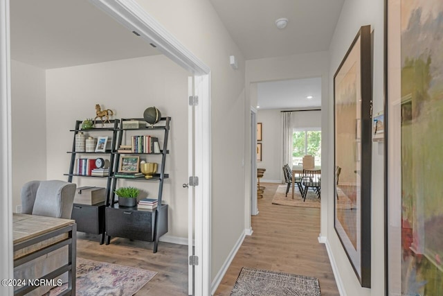 hallway with hardwood / wood-style flooring