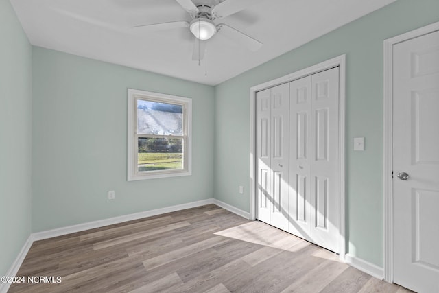 unfurnished bedroom with a closet, light hardwood / wood-style floors, and ceiling fan