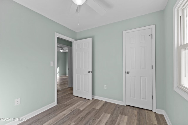 unfurnished bedroom with ceiling fan and light hardwood / wood-style flooring