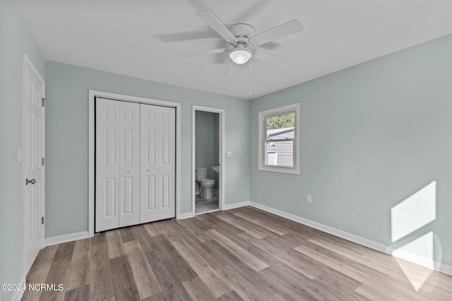 unfurnished bedroom with ceiling fan, a closet, connected bathroom, and light hardwood / wood-style floors