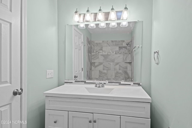 bathroom with vanity and tiled shower