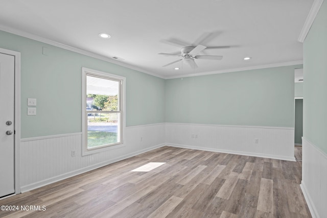 spare room with light hardwood / wood-style floors, ceiling fan, and crown molding