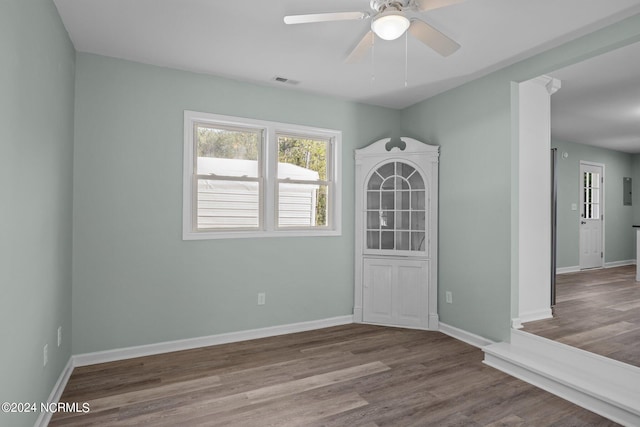 empty room with ceiling fan and wood-type flooring