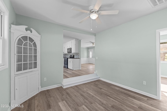 interior space with ceiling fan and light hardwood / wood-style flooring