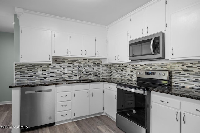 kitchen with stainless steel appliances, white cabinetry, and sink