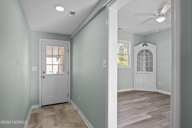 entryway featuring light hardwood / wood-style floors, ceiling fan, and plenty of natural light