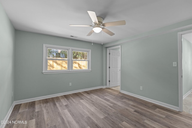 spare room with light hardwood / wood-style flooring and ceiling fan