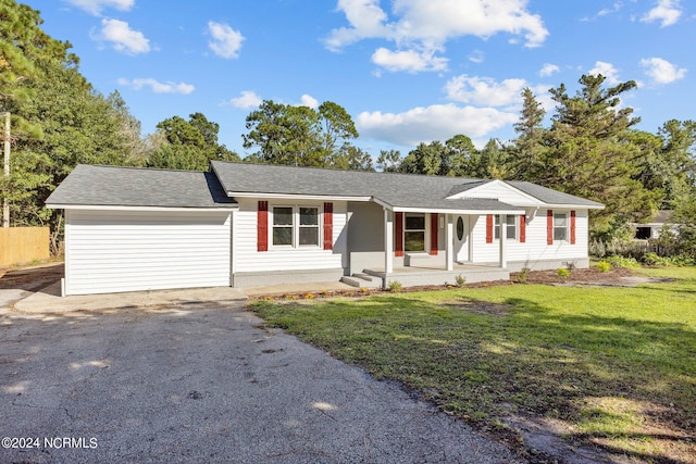 ranch-style house with a porch and a front lawn