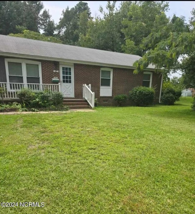 ranch-style home with a front lawn