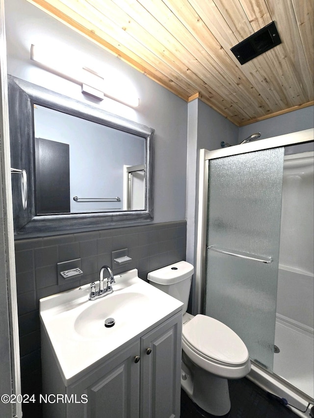 bathroom featuring wood ceiling, toilet, vanity, tile walls, and walk in shower