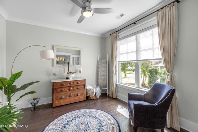 living area featuring ceiling fan, dark hardwood / wood-style floors, and ornamental molding