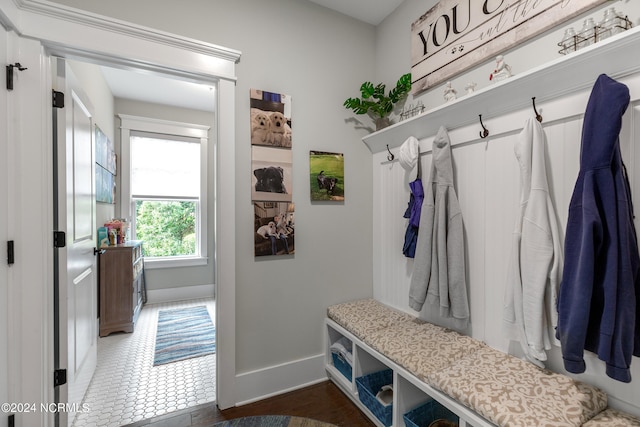 mudroom with dark tile patterned flooring